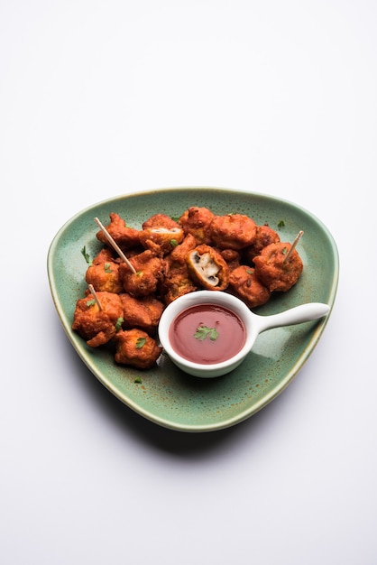 Mushroom 65, starter or appetiser food recipe from India. served in a plate with ketchup. selective focus