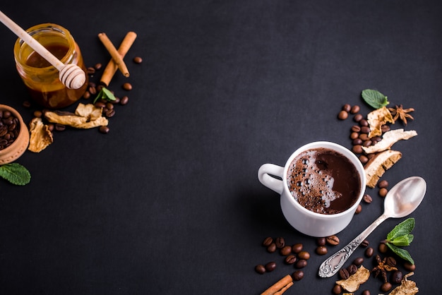 Mushroom Chaga Coffee Superfood Trend-dry and fresh mushrooms and coffee beans on dark background with mint.