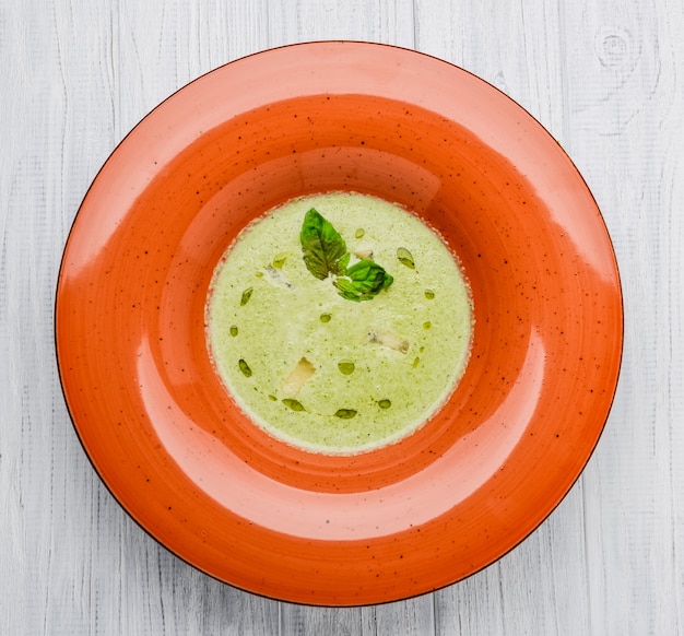 Mushroom cream soup on white wooden board