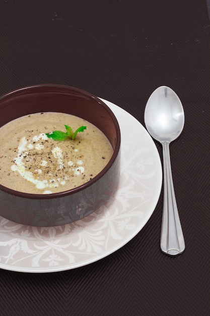 Mushroom cream soup with cream served in bowl Above Top view Vertical