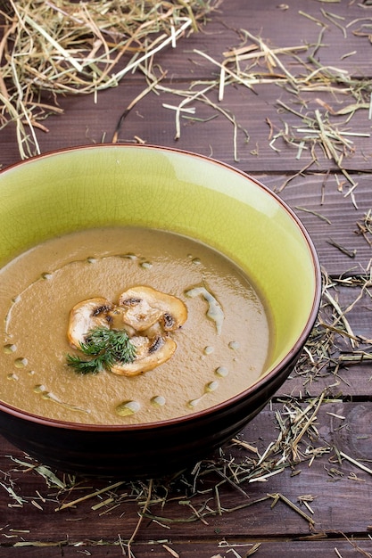 Mushroom cream soup on wooden background