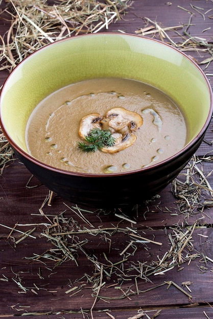 Mushroom cream soup on wooden background