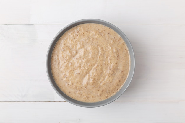 Mushroom cream soup on a wooden surface