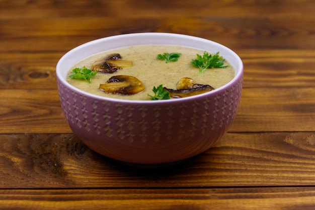 Mushroom cream soup on a wooden table