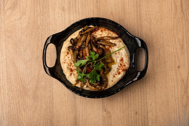 Mushroom hummus served in dish isolated on table top view of arabian food