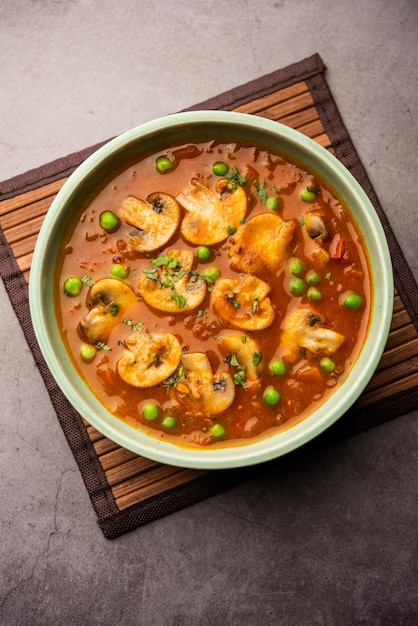 Mushroom and Pea Curry with Roasted Garlic Indian food served in a bowl