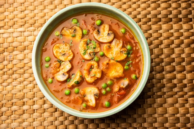 Mushroom and Pea Curry with Roasted Garlic Indian food served in a bowl