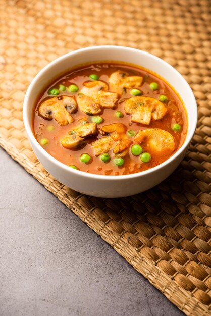 Mushroom and Pea Curry with Roasted Garlic Indian food served in a bowl