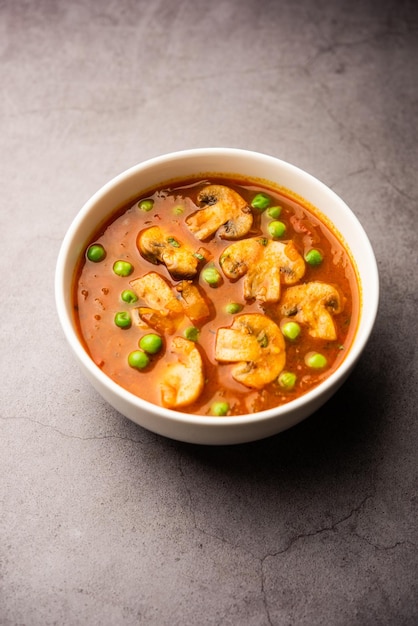 Mushroom and Pea Curry with Roasted Garlic Indian food served in a bowl