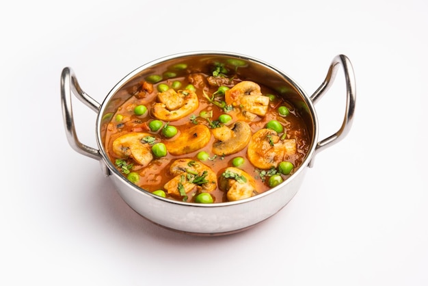 Mushroom and Pea Curry with Roasted Garlic Indian food served in a bowl