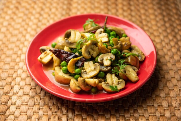 Mushroom and pea curry with roasted garlic indian food served in a bowl