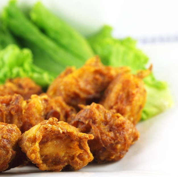 Mushroom snacks with lettuce over white background