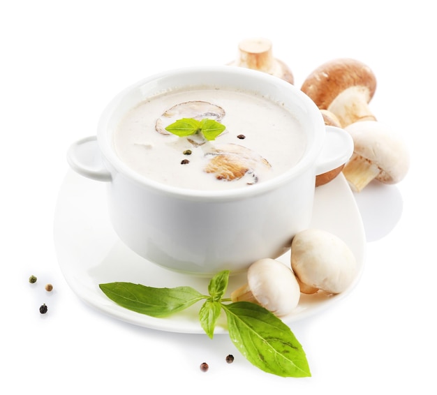 Mushroom soup in white bowl on plate isolated on white