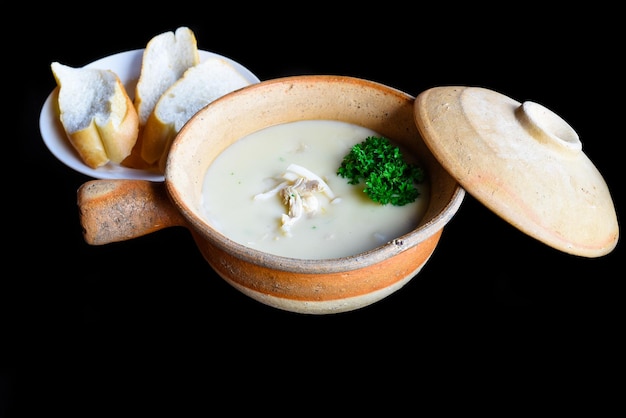 Mushroom Soup with chicken isolated on black background side view