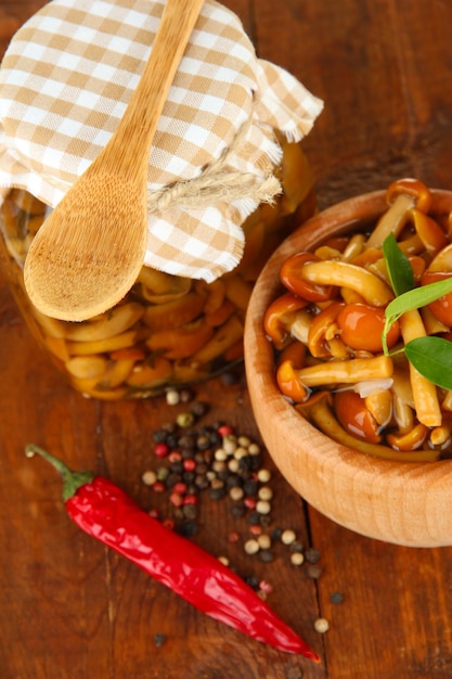 Mushrooms in bowl on wooden background