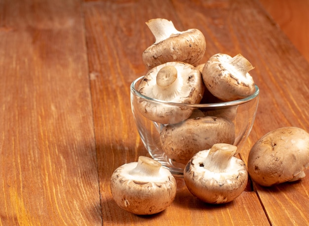 Mushrooms in a bowl on a wooden table