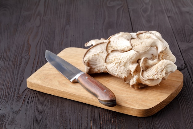 mushrooms and knife on wooden table