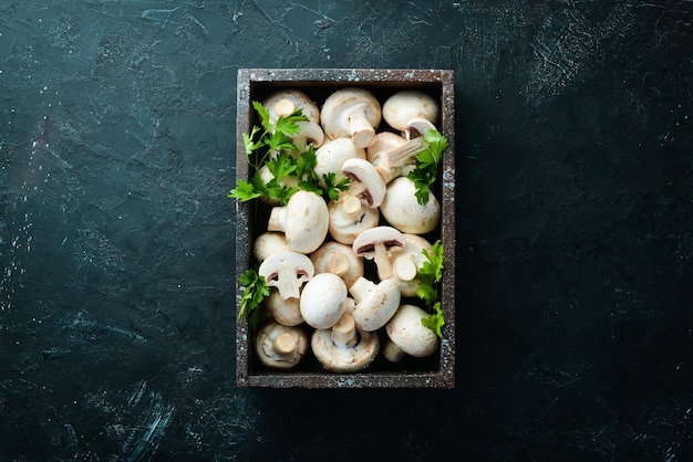 Mushrooms sliced on a black table surface Top view Free space for text