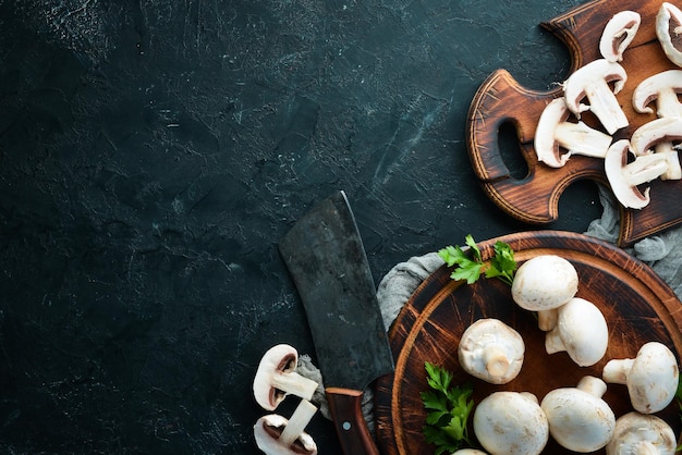 Mushrooms sliced on a black table surface Top view Free space for text