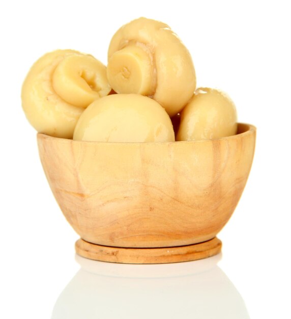 Mushrooms in wooden bowl isolated on white