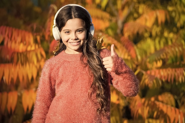 Music for autumn mood Listening song Enjoy music fall day Listening audio best way help child improve vocabulary Kid girl relaxing near autumn tree with headphones Autumn walks with nice songs