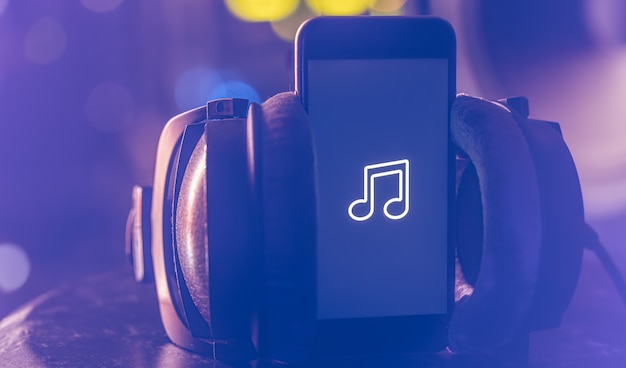 Music background with phone and with music icon, modern technology concept, listening to music.