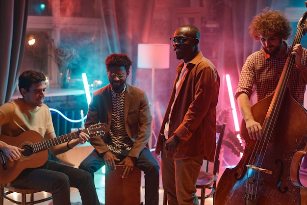 Music band playing musical instruments they rehearsing in the studio