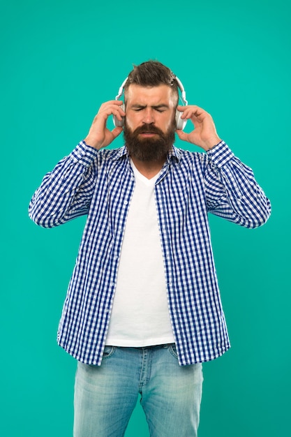 Music. brutal caucasian hipster with moustache. Happy man hipster listen to music. Bearded man. Hair and beard care. Man in earphones. Young and brutal. Mature hipster with beard. e book education.