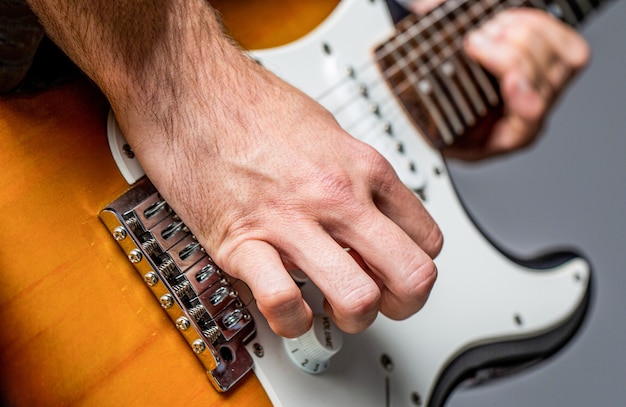 Music festival. Man playing guitar. Close up hand playing guitar. Musician playing guitar, live music. Musical instrument