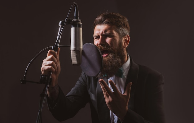 Music festival singer performing a song with a microphone while\
recording in a music studio