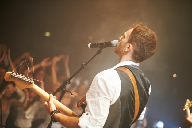 Music from the heart Shot of a frontman in a band singing on stage