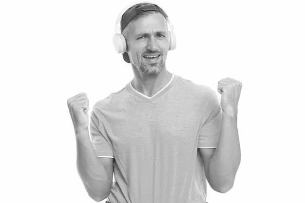 Music makes me happy Happy man listen to music isolated on white Handsome guy make winner gesture Happy music Fun and entertainment Happy new mix Pleasure and joy Super hit
