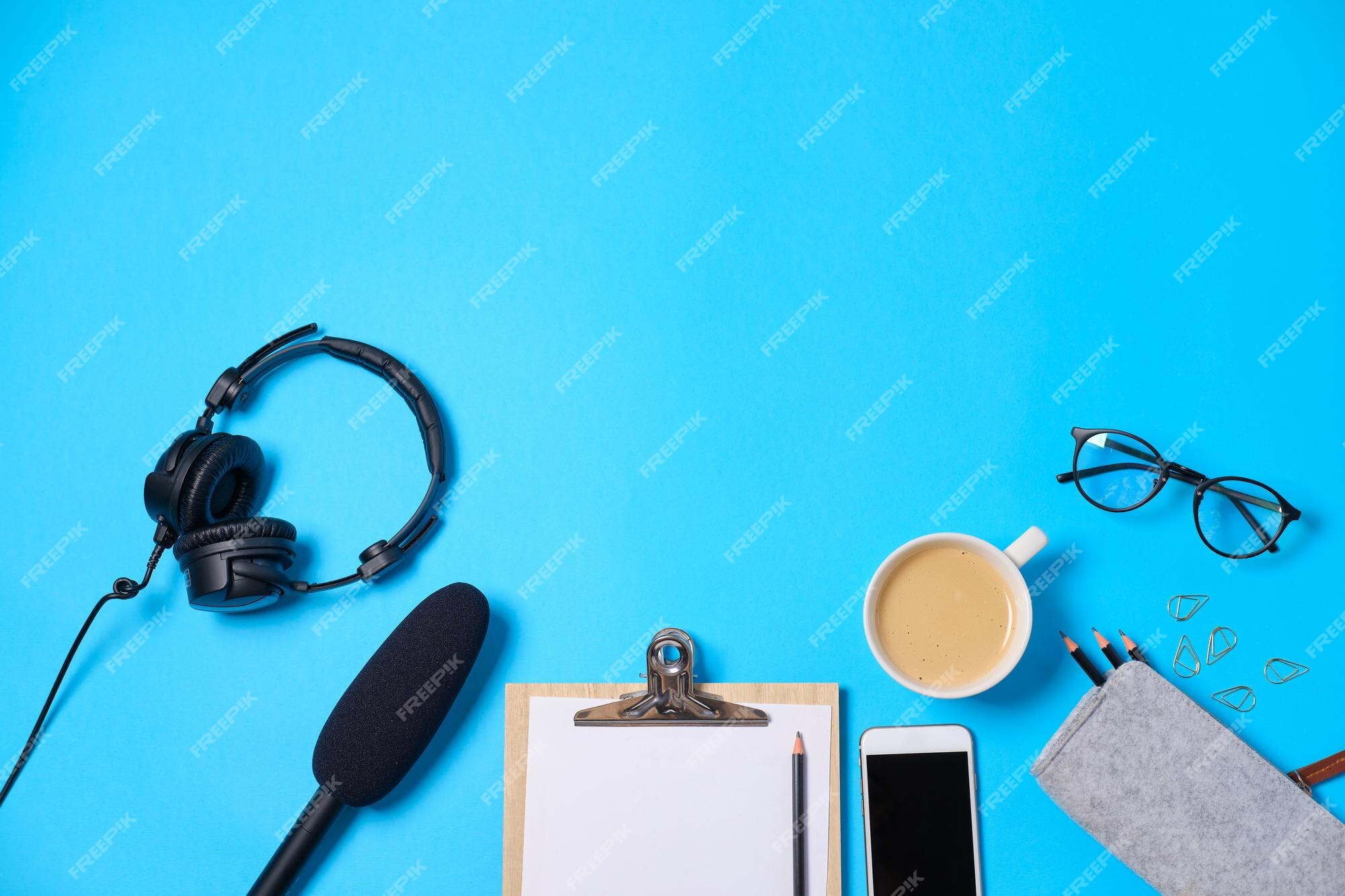 Premium Photo | Music or podcast background with headphones microphone  coffee and blank on blue table flat lay top view flat lay