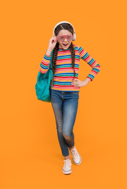 Music school Teen girl singing along to music after school yellow background music