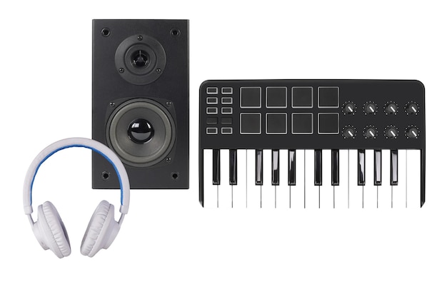 Music and sound One loudspeaker enclosure MIDI keyboard and white headphone Isolated