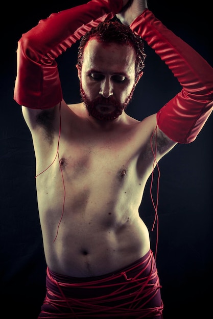 Music star, guitarist wearing face paint and red leather