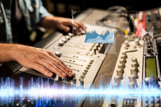 Photo music technology people and equipment concept sound engineer hands using mixing console at recording studio