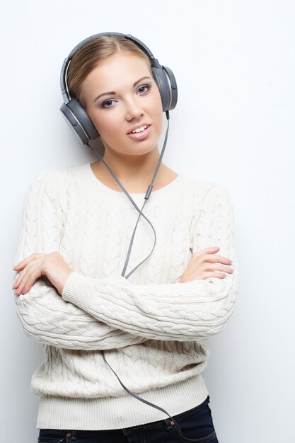 Music teenager girl dancing against white .