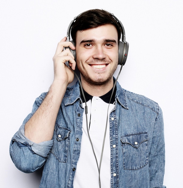 Music Young man wearing headphones and holding mobile phone