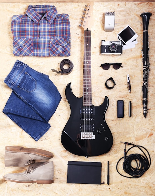 Musical equipment, clothes and footwear on wooden