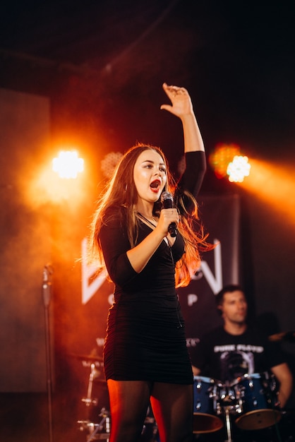 Musical group, band, on stage in bright rays