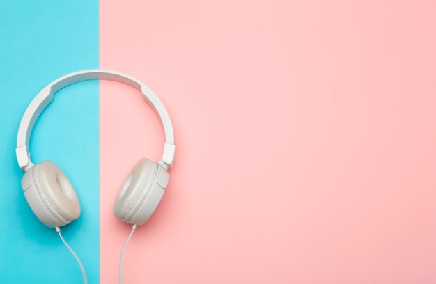 Musical headphones on a colored blue and pink background