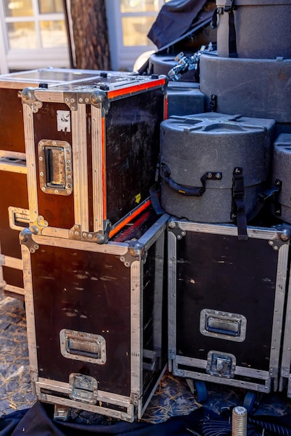 Musical instrument cases stand one at another outdoor equipment
for concert