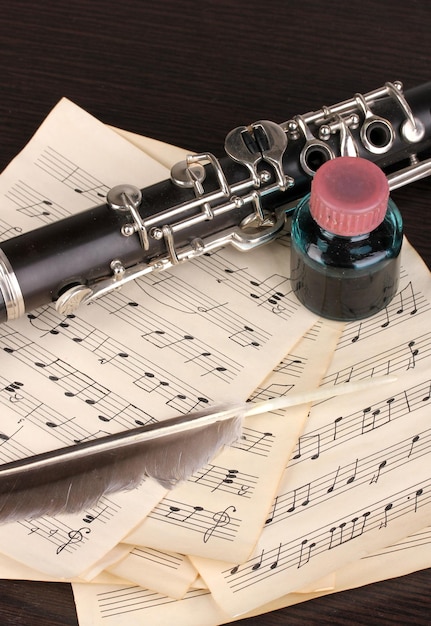 Musical notes and clarinet on wooden table