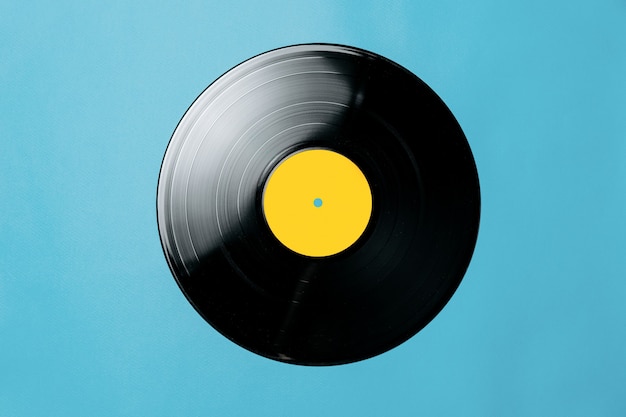 musical record on a blue background flat lay