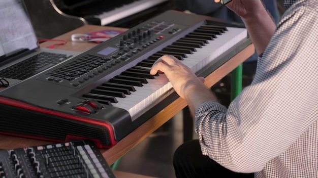a musician actively performing with a keyboard in a professional recording studio environment clip