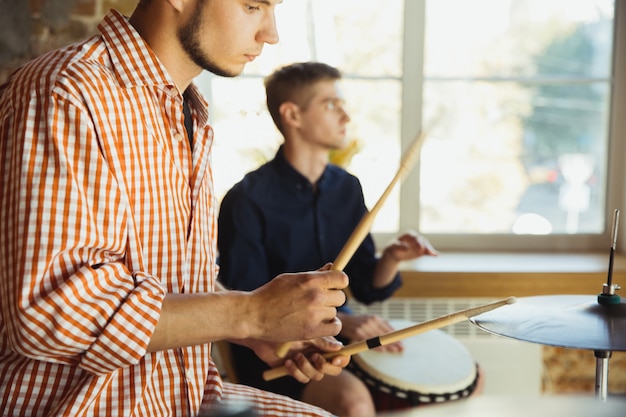 Photo musician band jamming together in art workplace with instruments