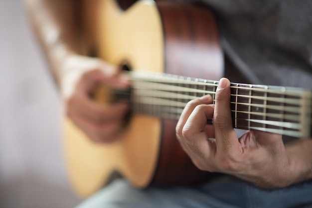 Musician man playing acoustic guitar