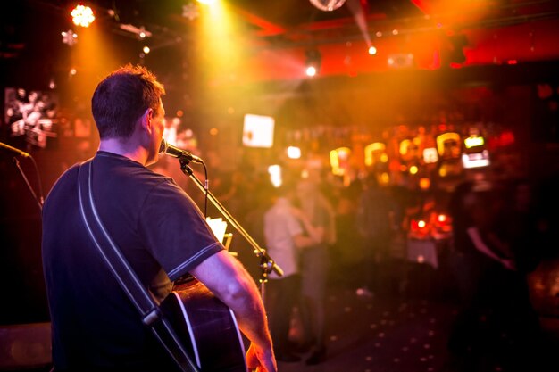 musician plays a guitar on stage