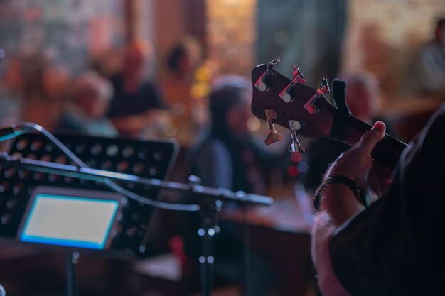 Musician seen playing guitar with blurred background